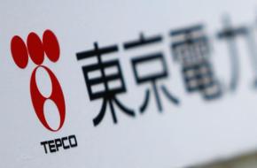 A TEPCO logo is pictured on a sign showing the way to the venue of the company's annual shareholders' meeting in Tokyo